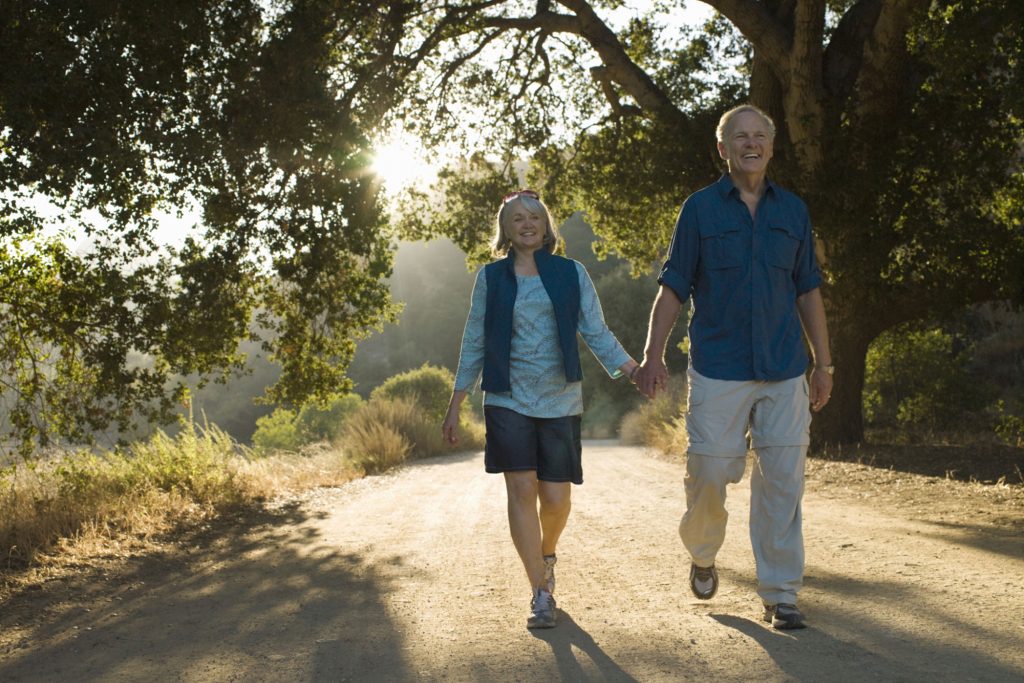 couple holding hands while walking